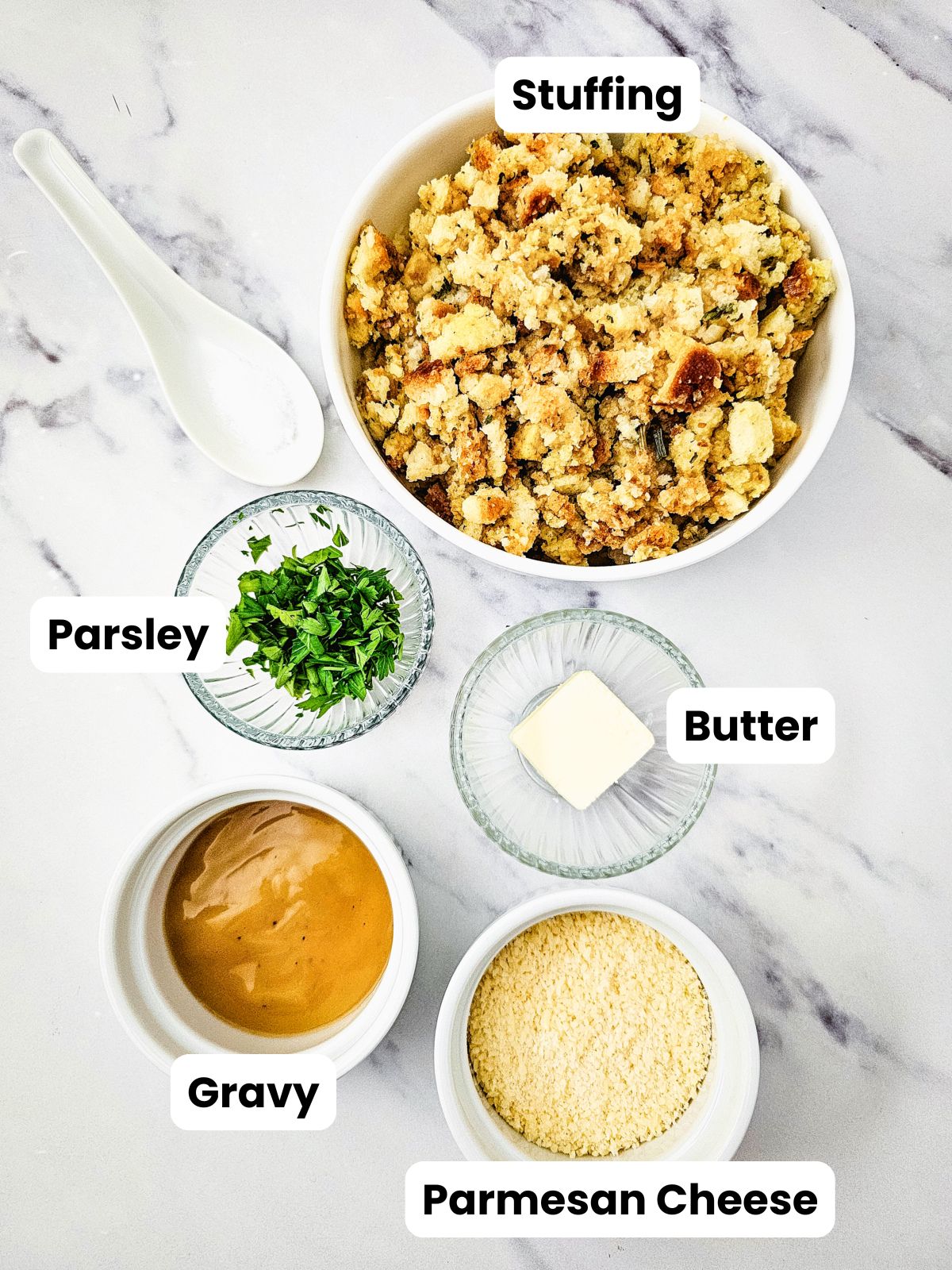 Ingredients for stuffing muffins showing pre-cooked stuffing, chopped parsley, butter, gravy, and Parmesan cheese.