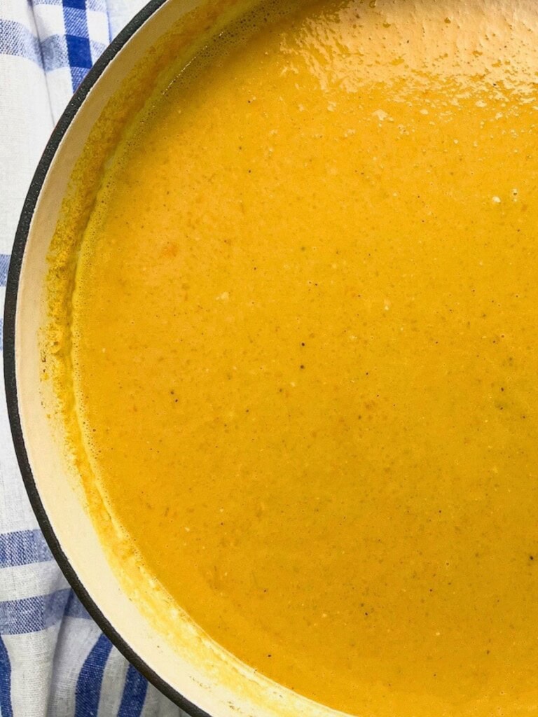 A large pot of homemade sweet potato carrot soup.