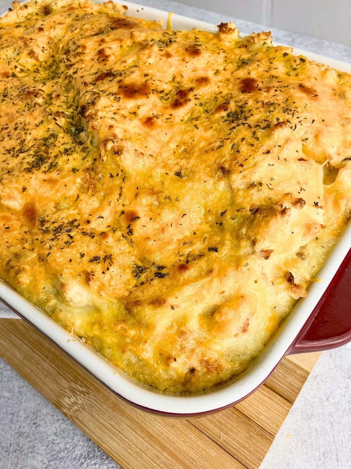 Turkey bacon loaded mashed potato casserole topped with cheese.