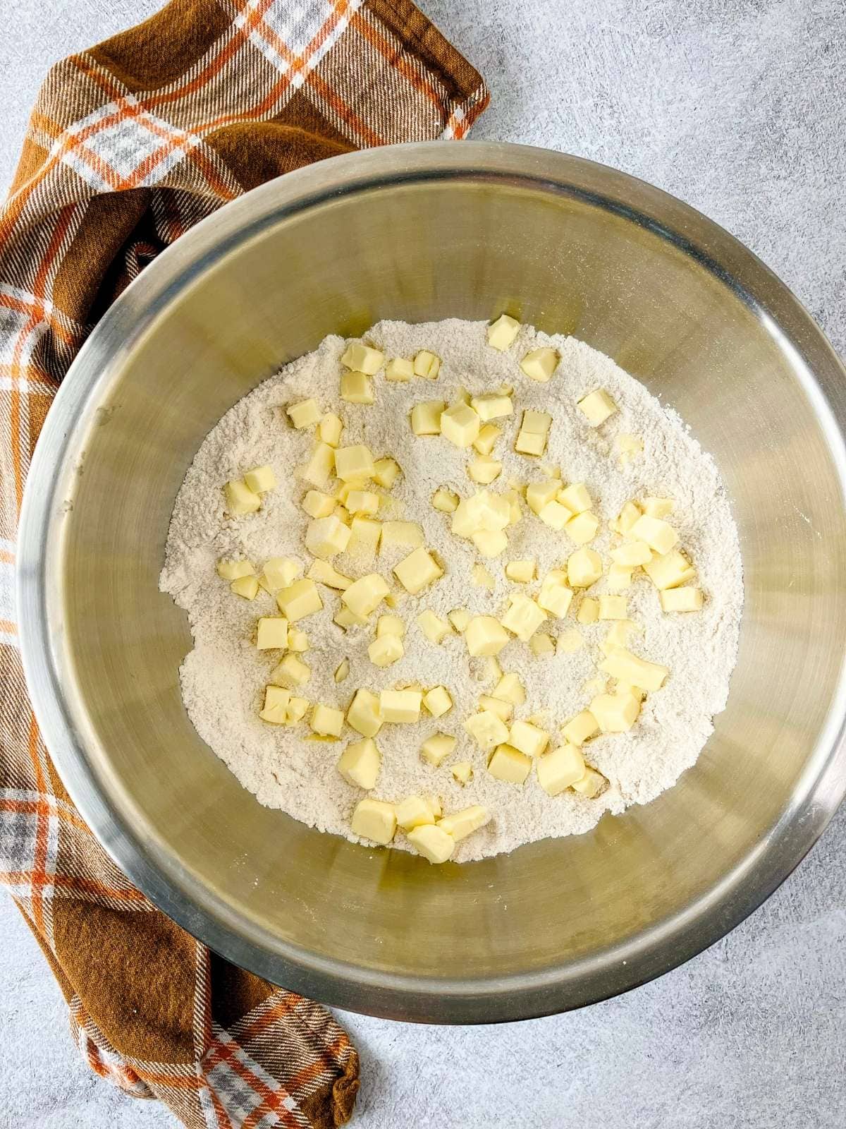 Cubed butter added to the flour mixture.