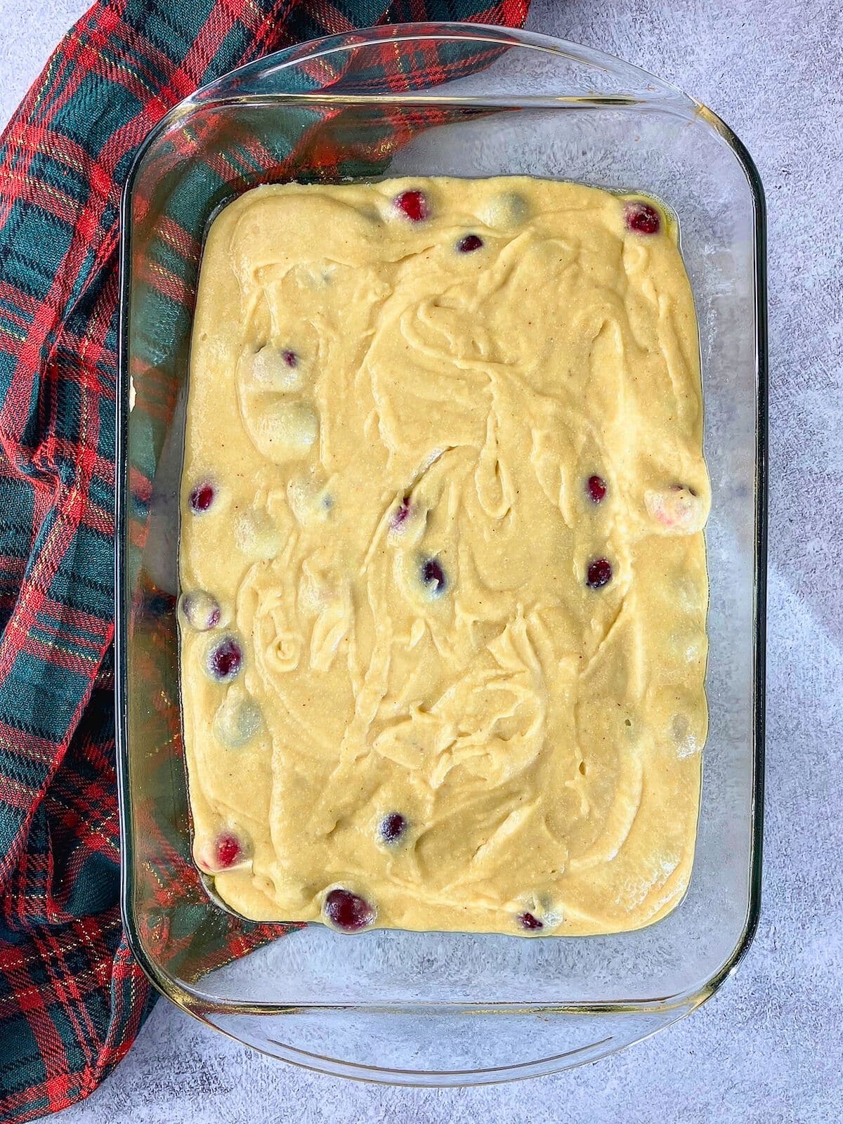 The cornbread batter was poured into a baking dish.
