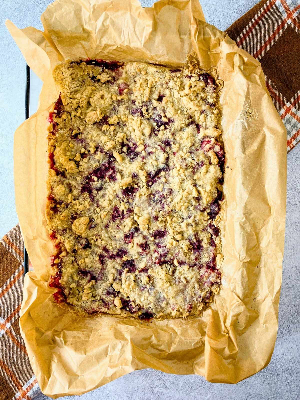 Homemade cranberry squares cooling in a baking dish.