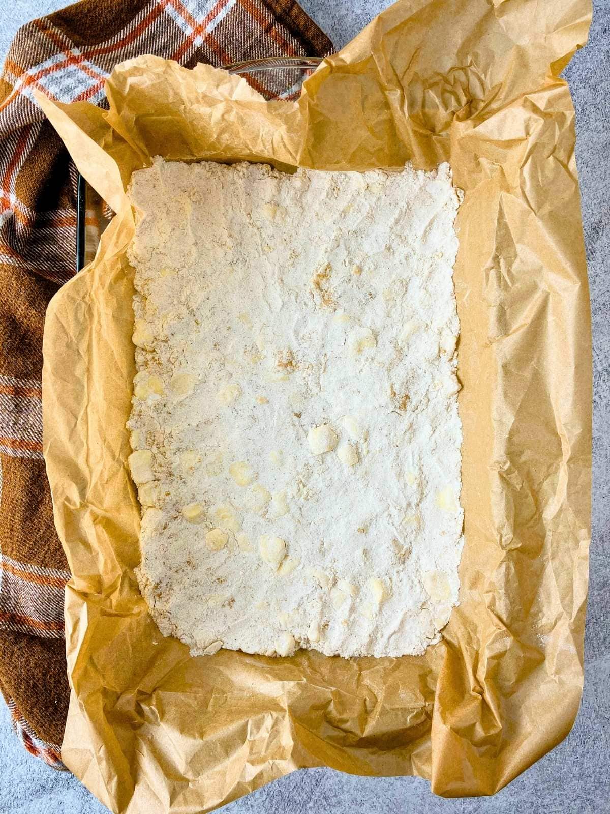 The crust was patted out into a baking dish lined with parchment paper.