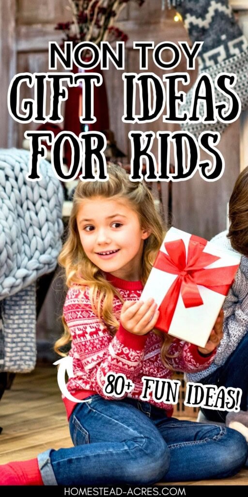 A young girl sitting on the floor holding a wrapped gift. The text overlay says Non Toy Gift Ideas For Kids 80 Plus Fun Ideas.
