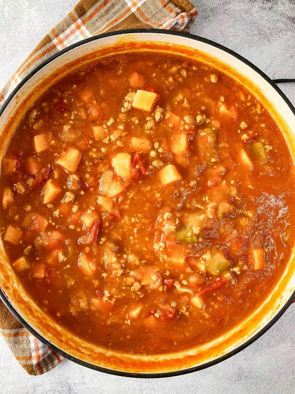 A large pot of homemade pumpkin sweet potato chili.