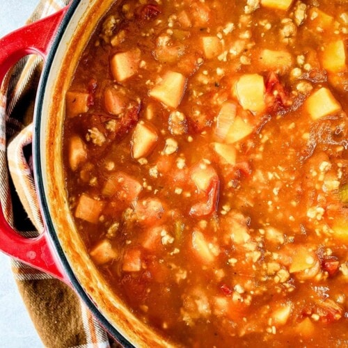 A large cast iron pot of homemade pumpkin sweet potato chili.