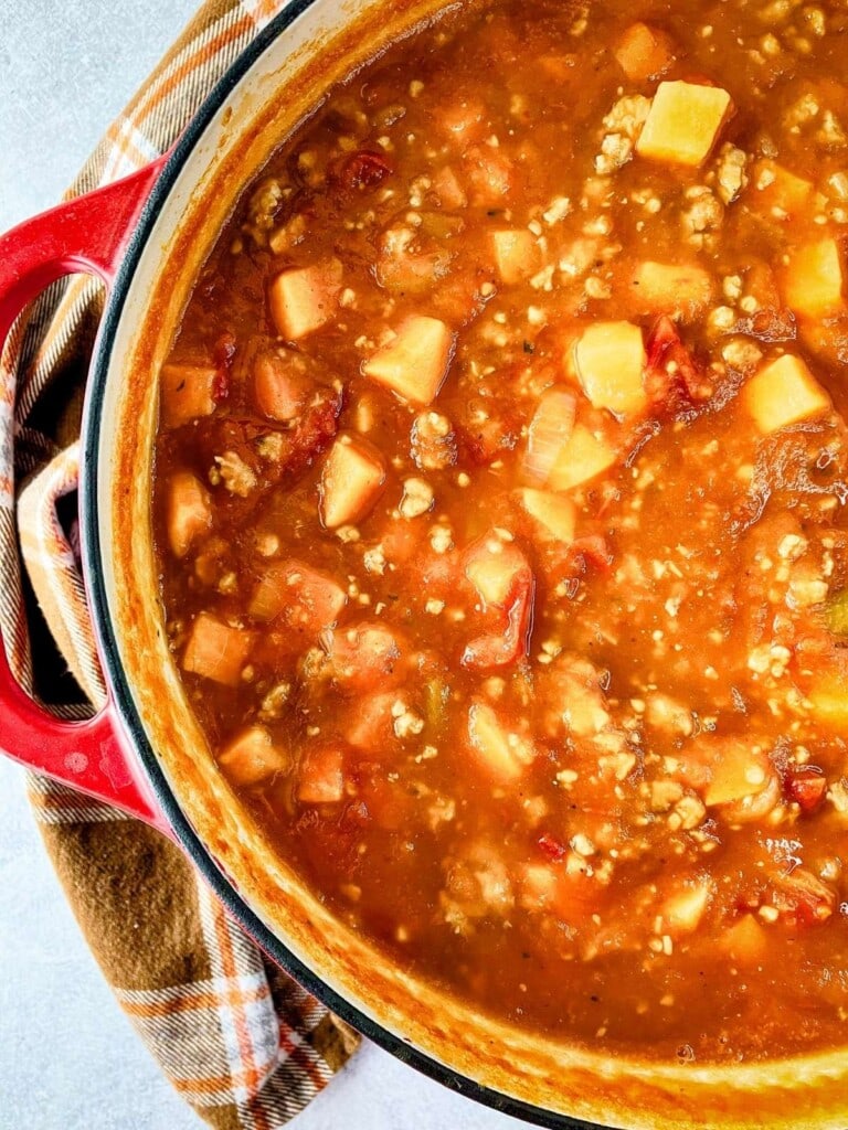 A large cast iron pot of homemade pumpkin sweet potato chili.