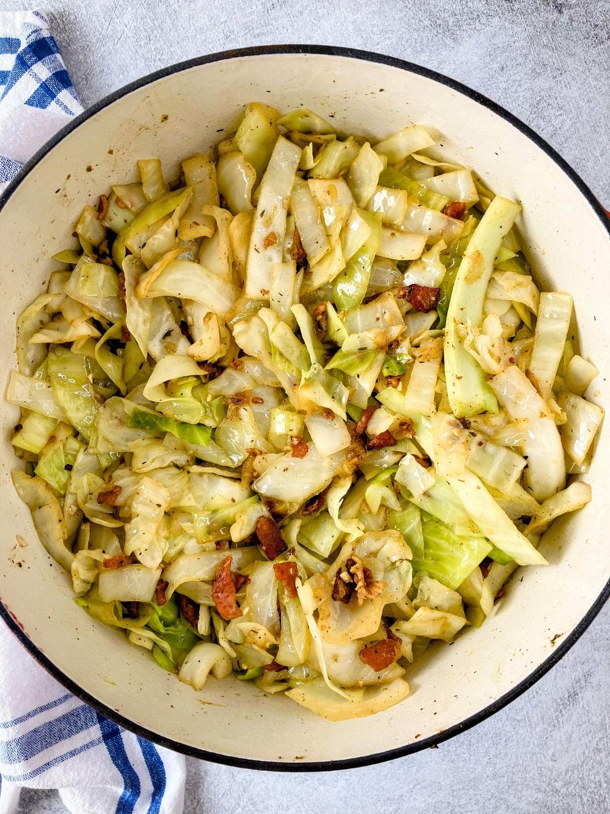 Simple fried cabbage with bacon cooked in a large Dutch oven.