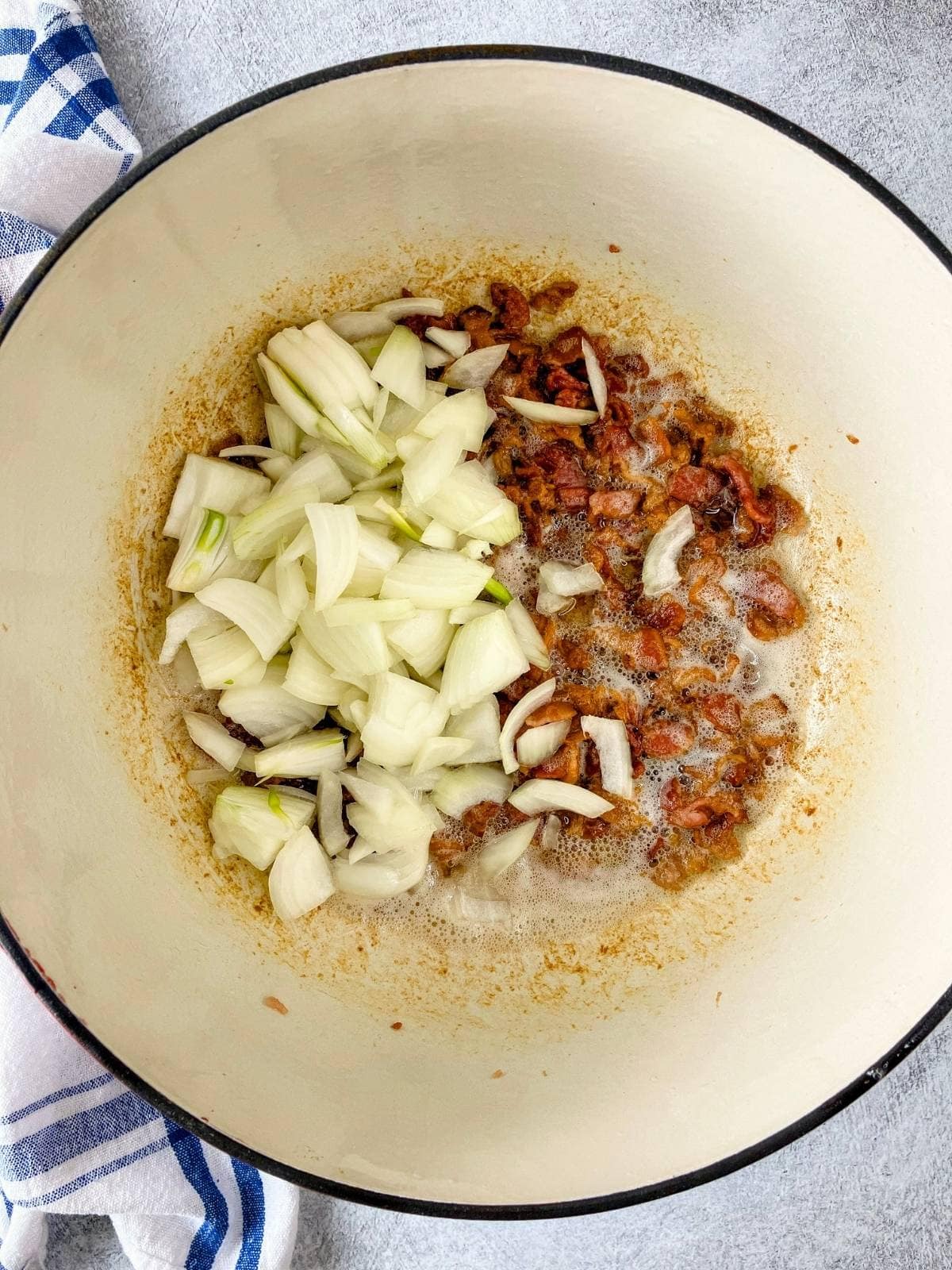 Diced onion was added to the cooked bacon.