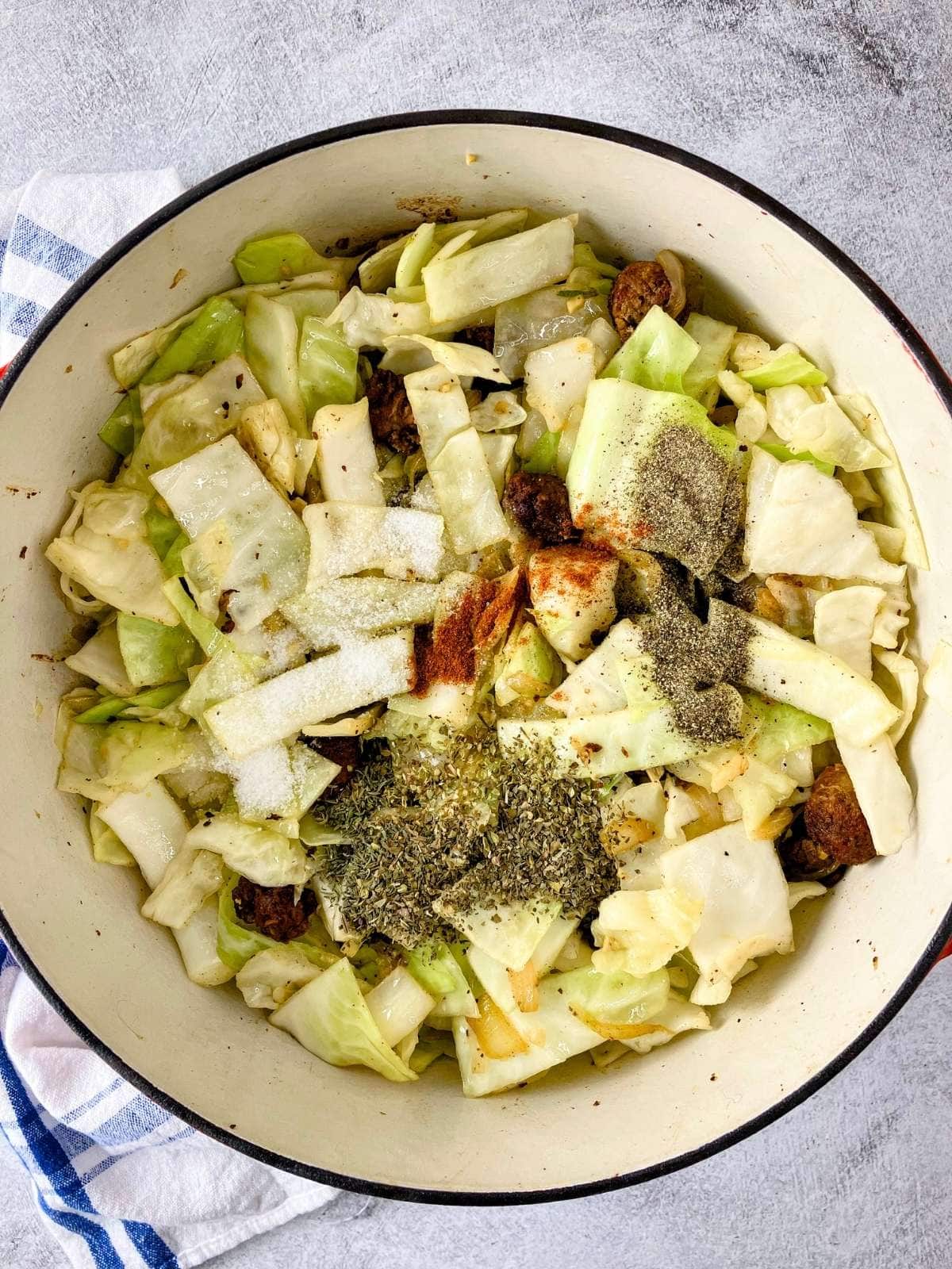 Salt, pepper, and spices were added to the half-cooked cabbage.