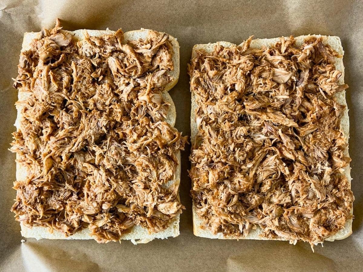 A layer of shredded BBQ chicken was spread over the bottom rolls.