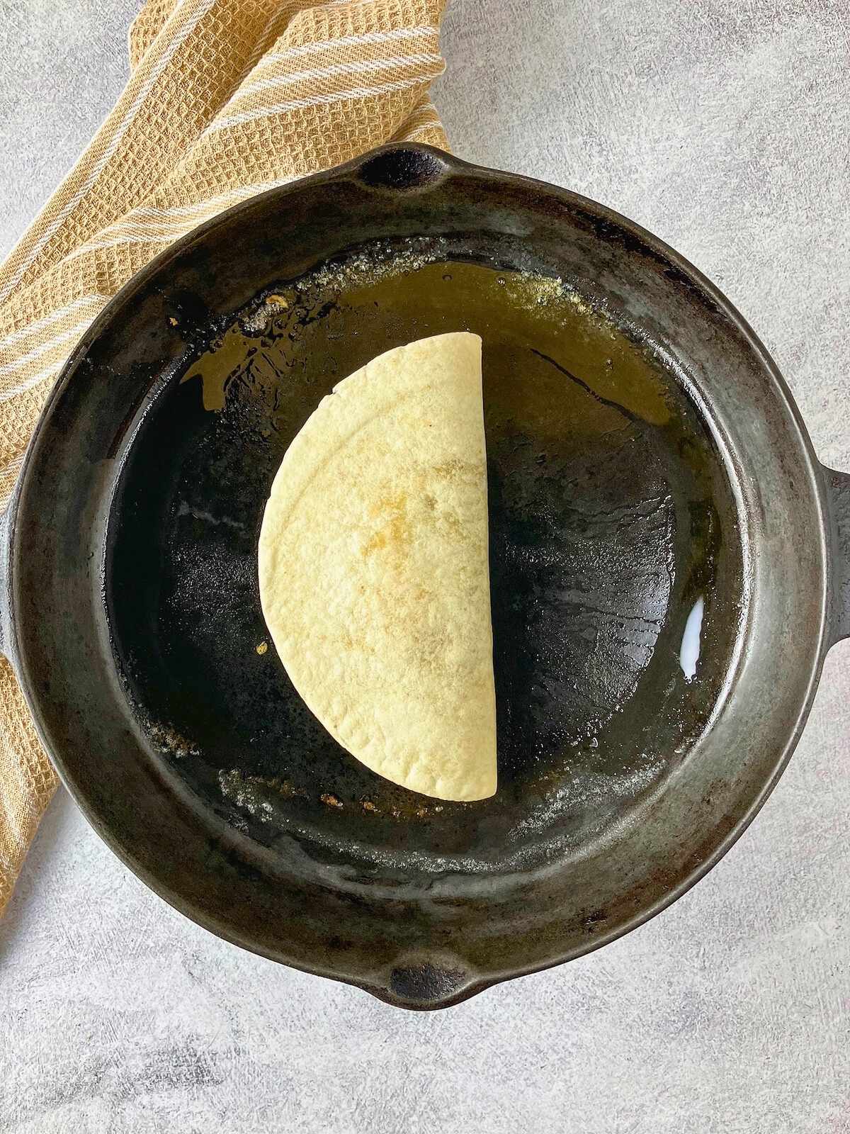 The filled tortilla was placed into a hot frying pan.