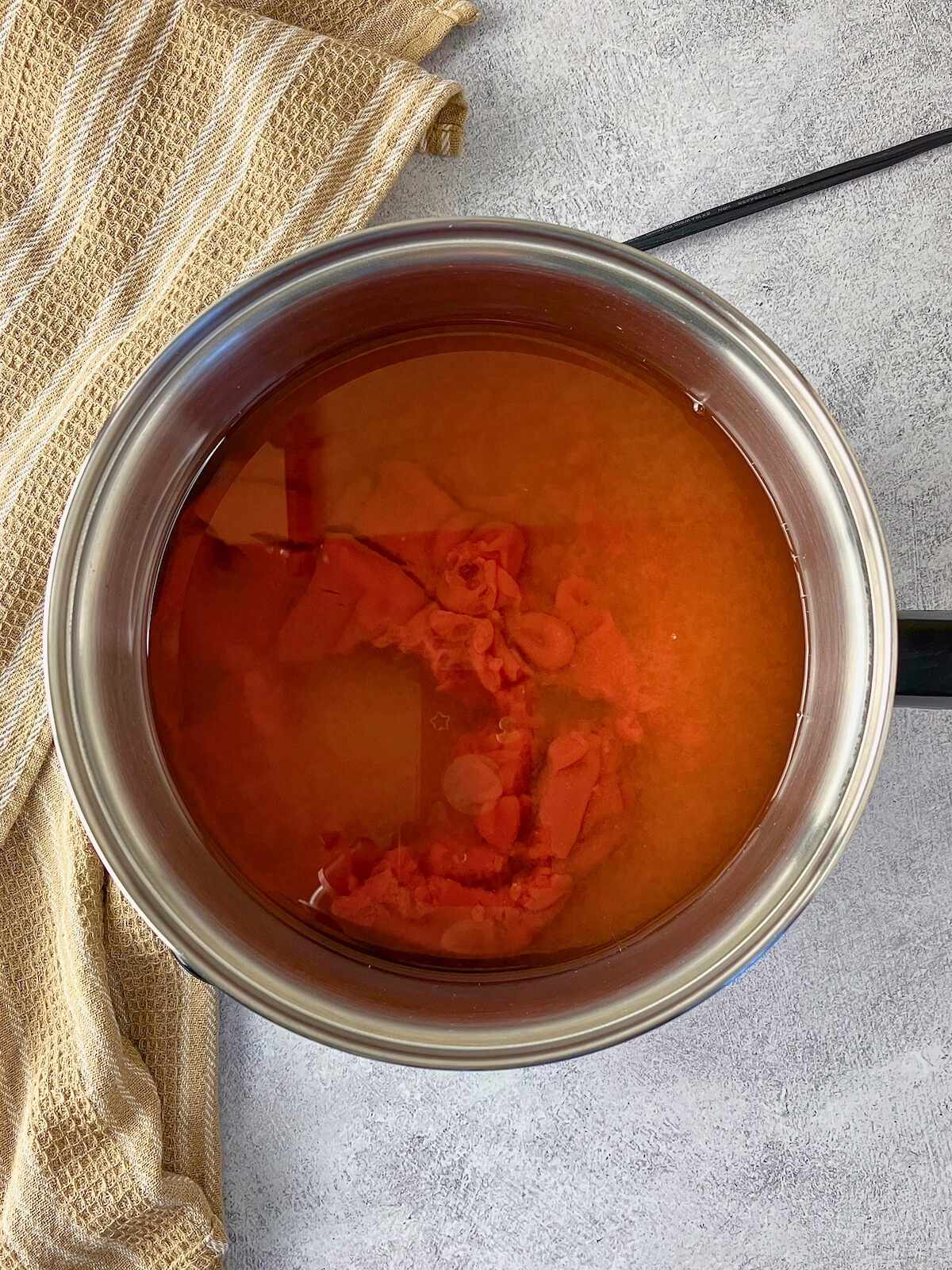 The ketchup and vinegar were added to the saucepot.