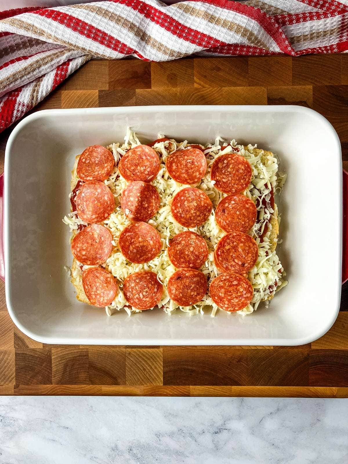 A layer of sliced pepperoni was placed over the shredded cheese.