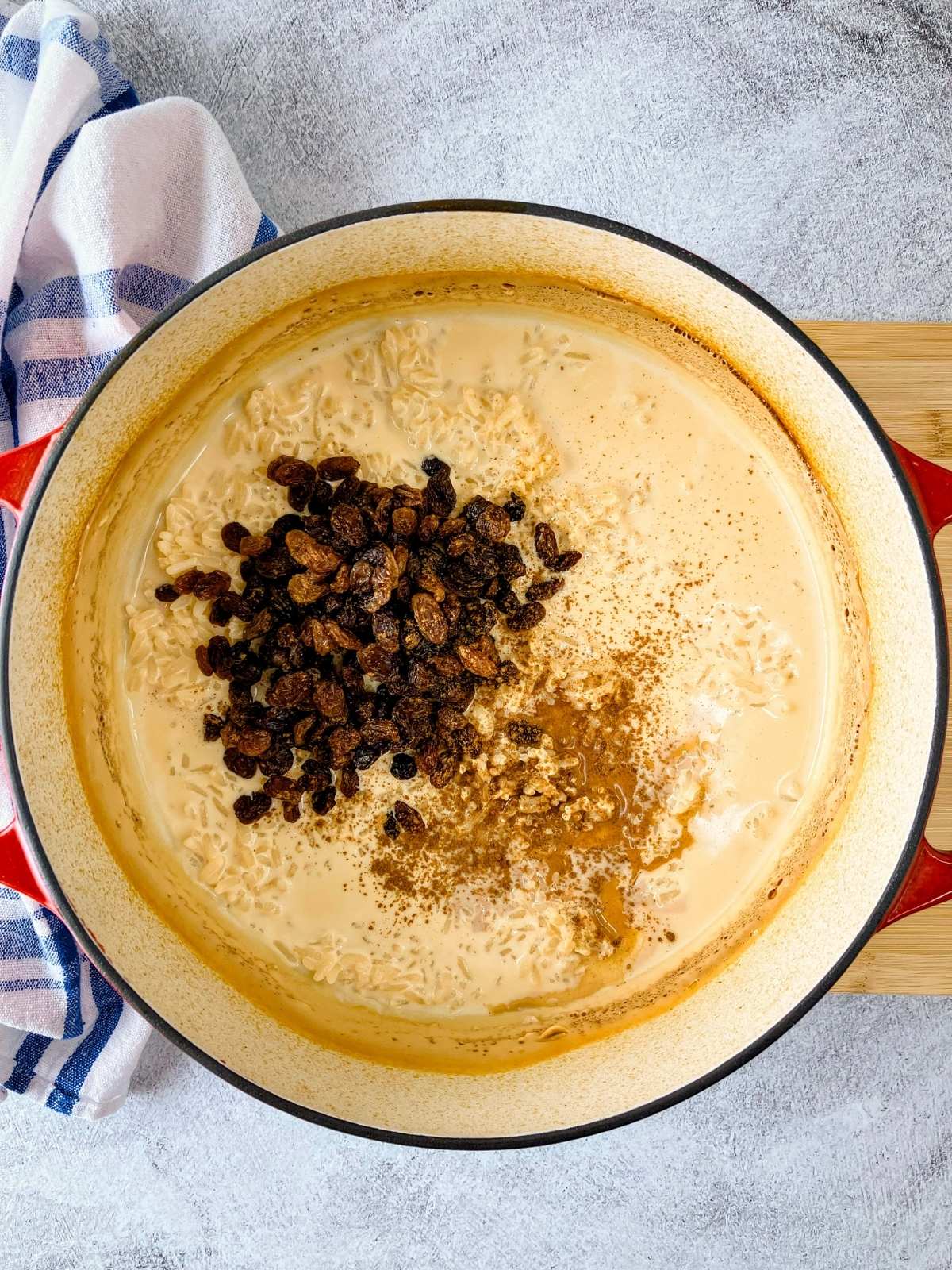 The raisins and cinnamon were added to the rice pudding.