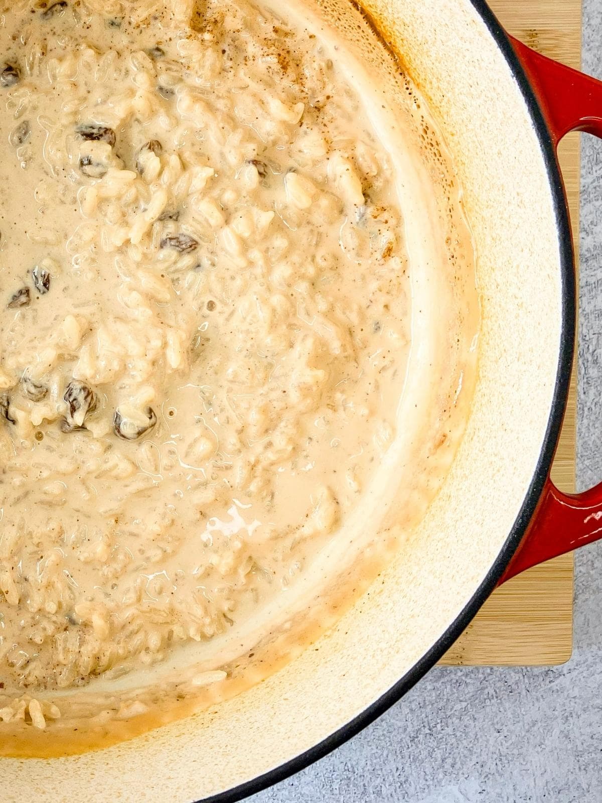 A Dutch oven filled with baked rice pudding.