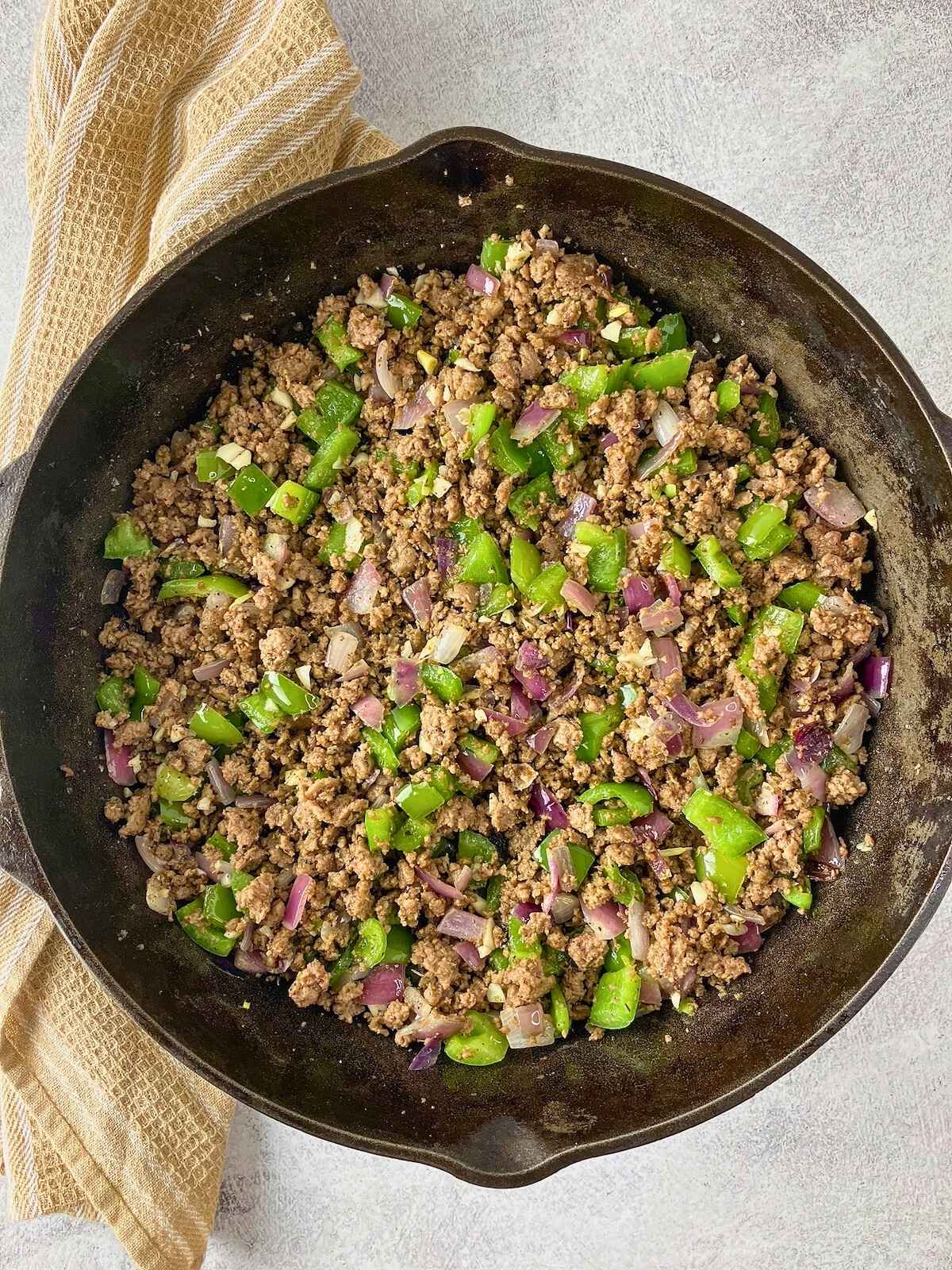 The seasonings have been stirred and cooked into the meat and vegetable mixture.