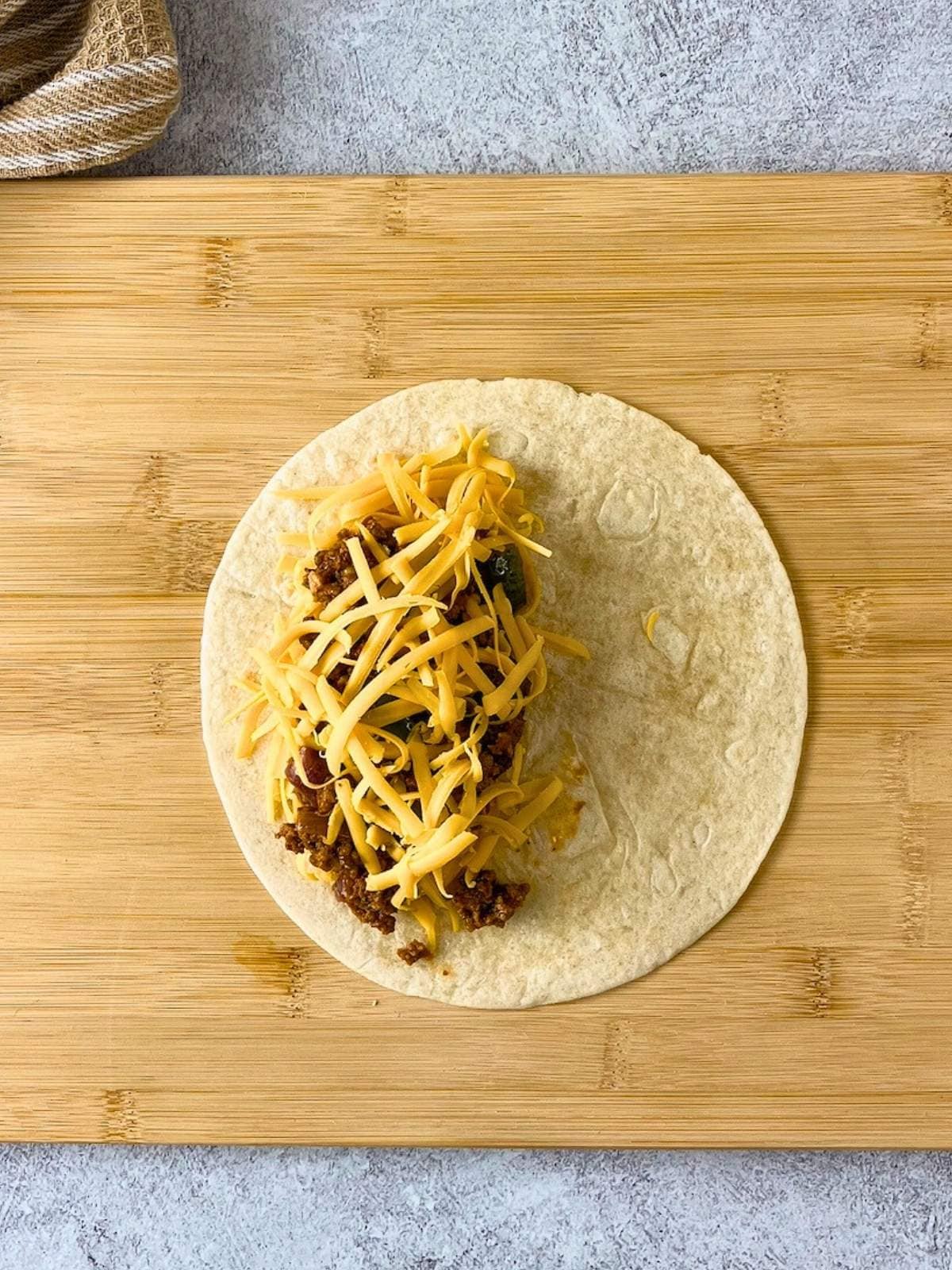 The final layer of shredded cheese was sprinkled over the filling.