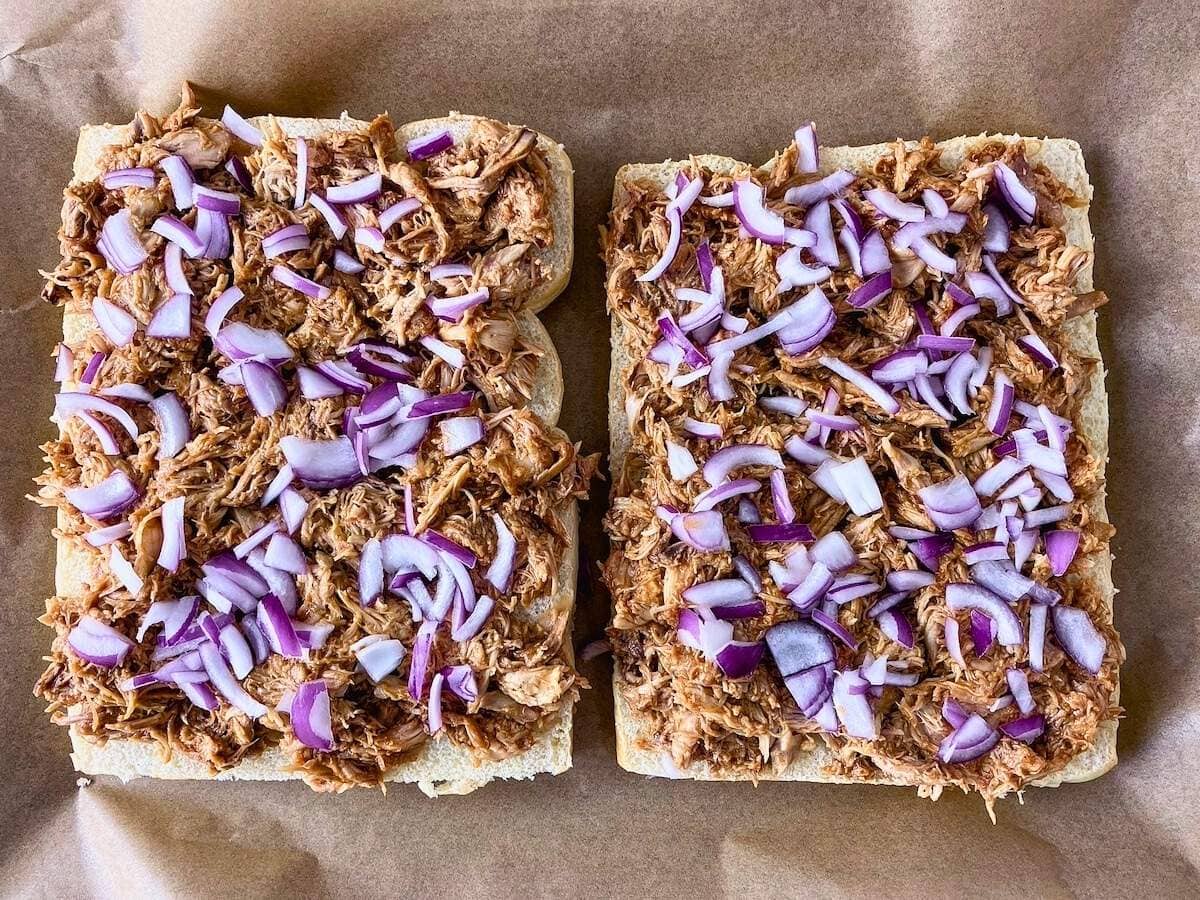 The sliced red onion was placed over the chicken.