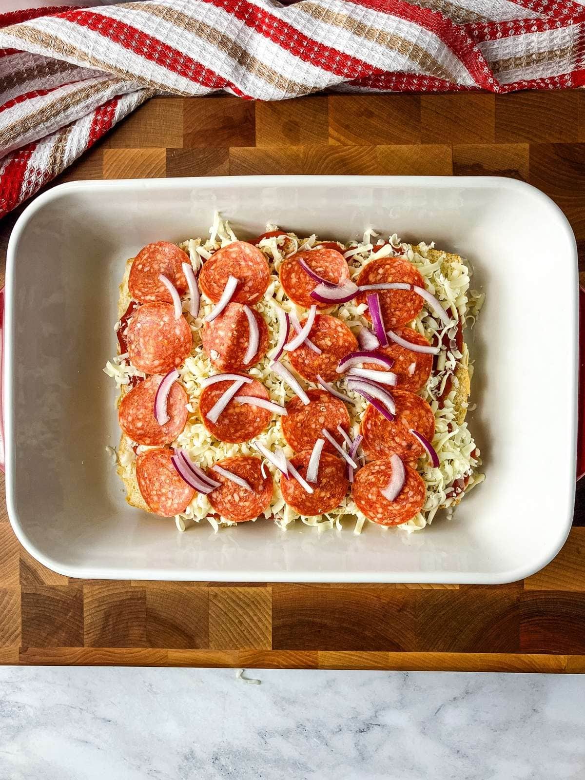 A layer of sliced red onion was added on top of the pepperoni.