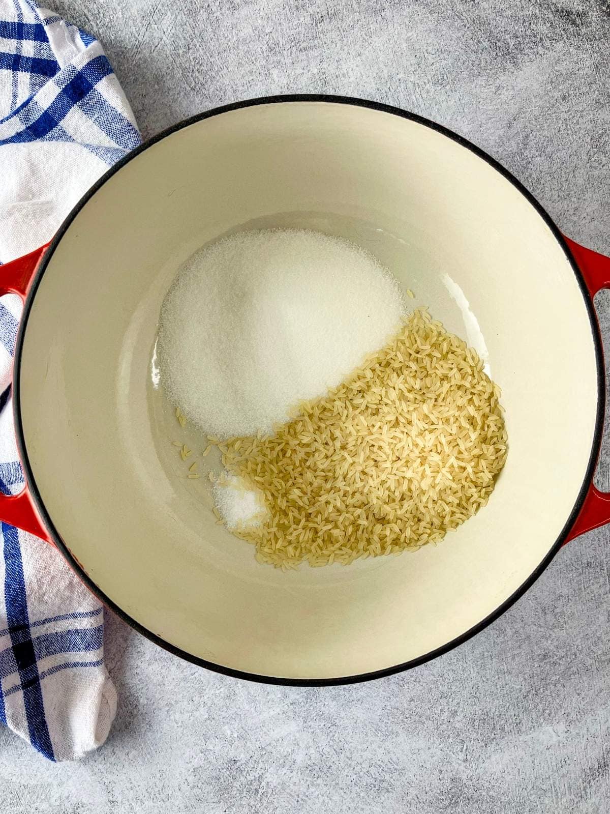 Rice, sugar, and salt were added to the Dutch oven.