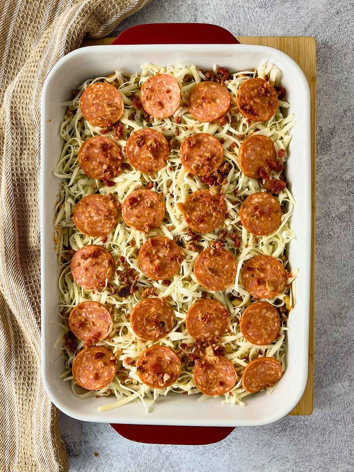 Bacon bits were sprinkled over the top of the pepperoni and cheese layers.