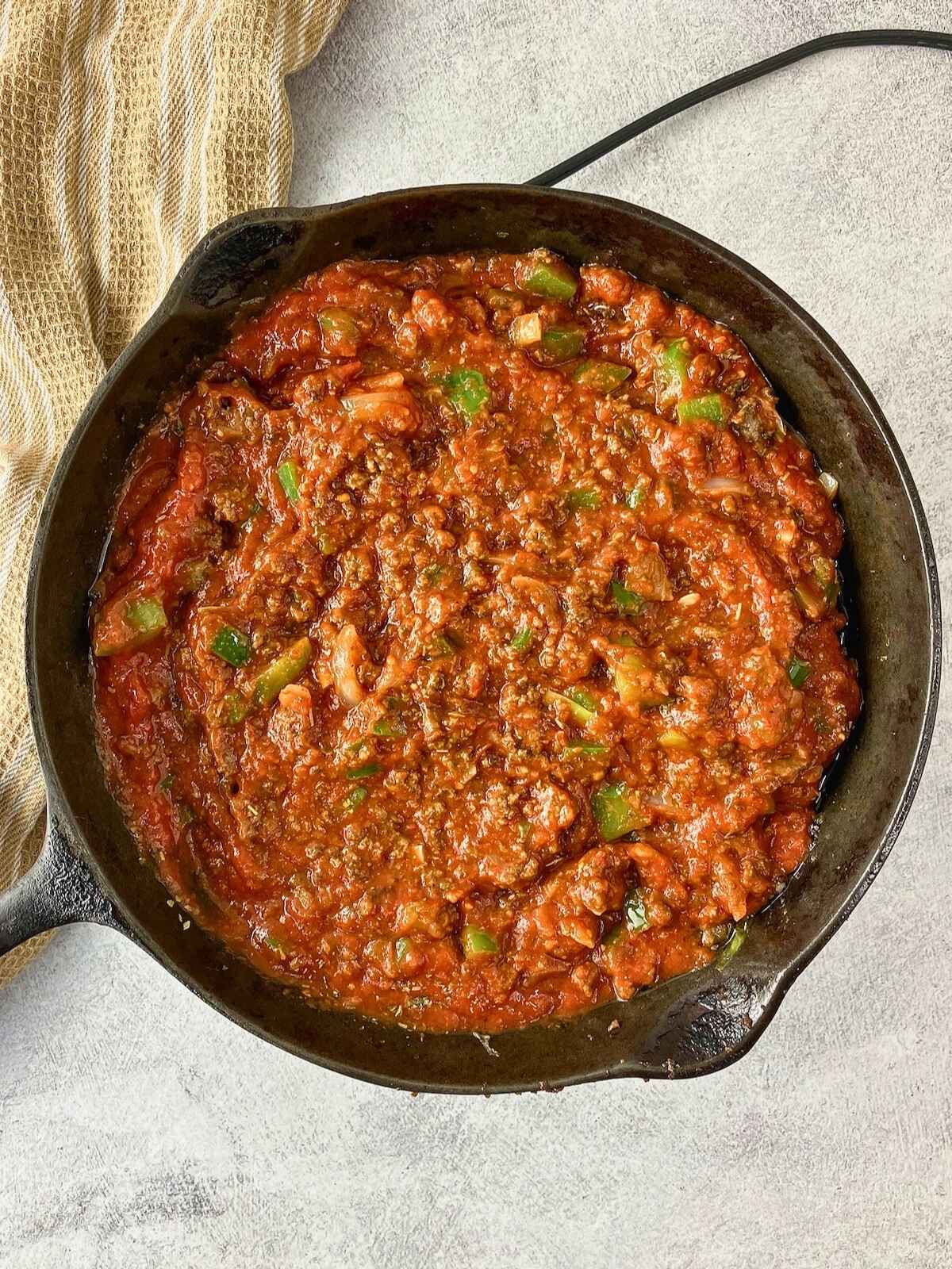 Cooked meat sauce in a cast iron skillet.