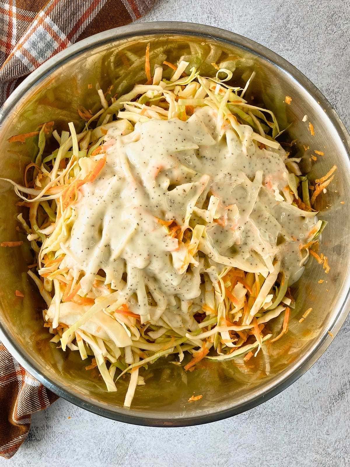 The dressing has been poured over the shredded vegetables.