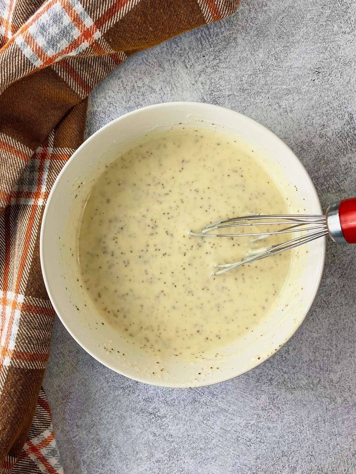 The creamy coleslaw dressing was whisked together.
