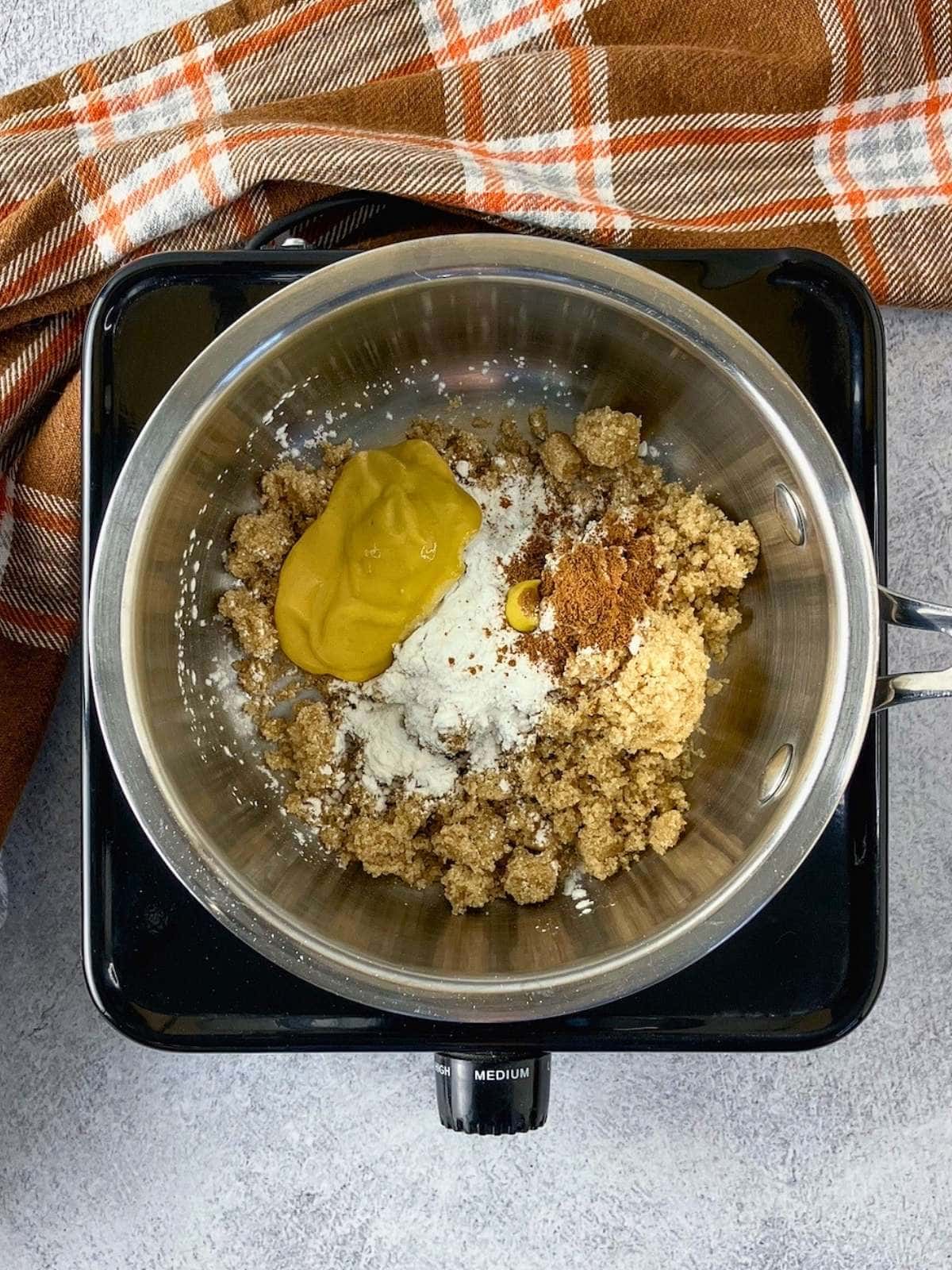 The mustard, cornstarch, and seasonings were added to the pot.