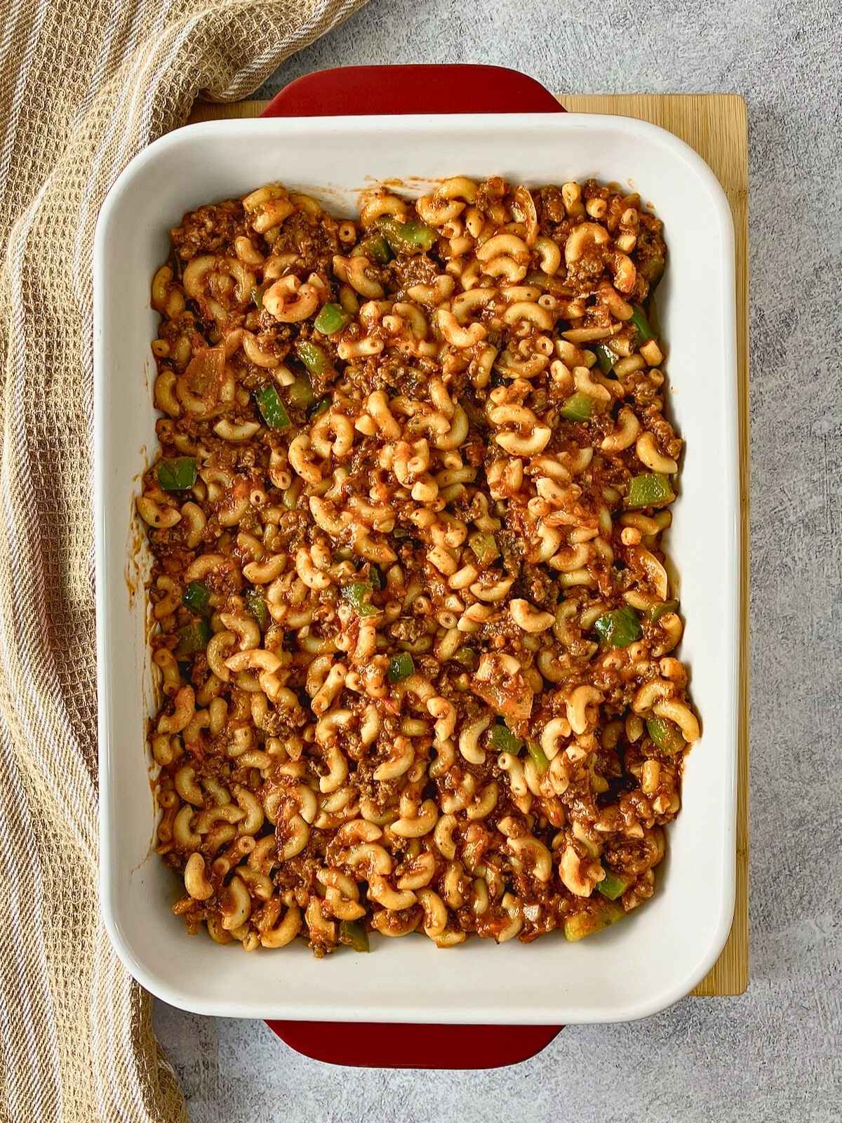 The cooked pasta and meat sauce were spread into a casserole dish.