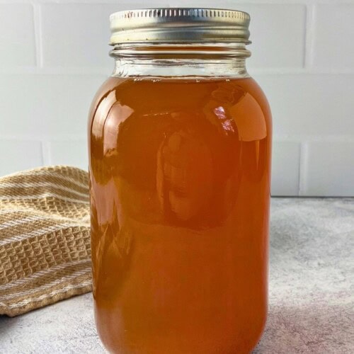 A quart jar of homemade vegetable broth made in the Instant Pot.