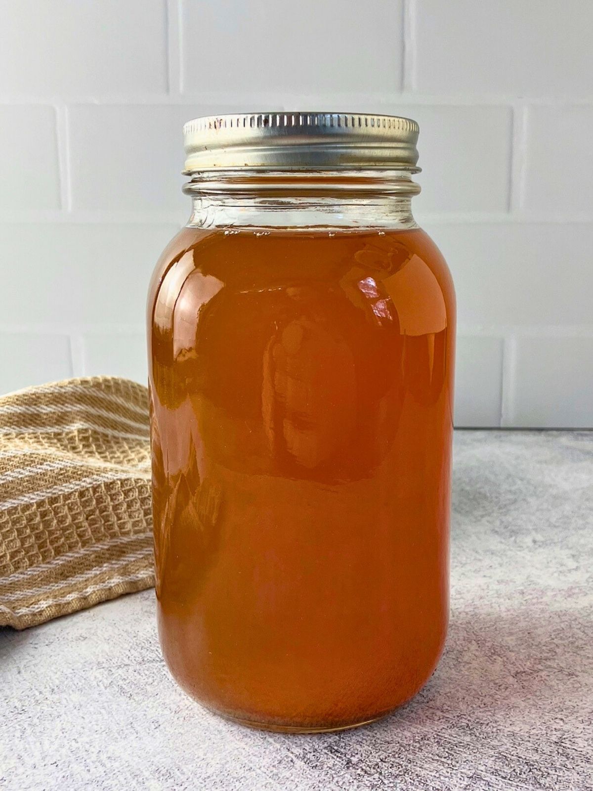 A quart jar of homemade vegetable broth made in the Instant Pot.