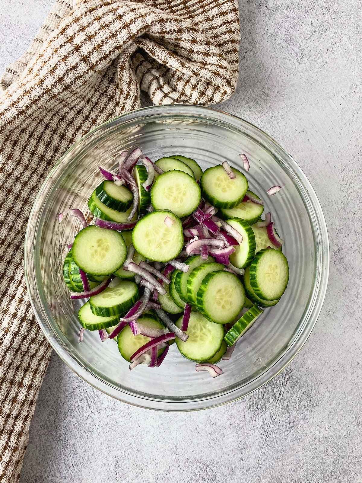 The drained onions and cucumbers were placed back into the mixing bowl.