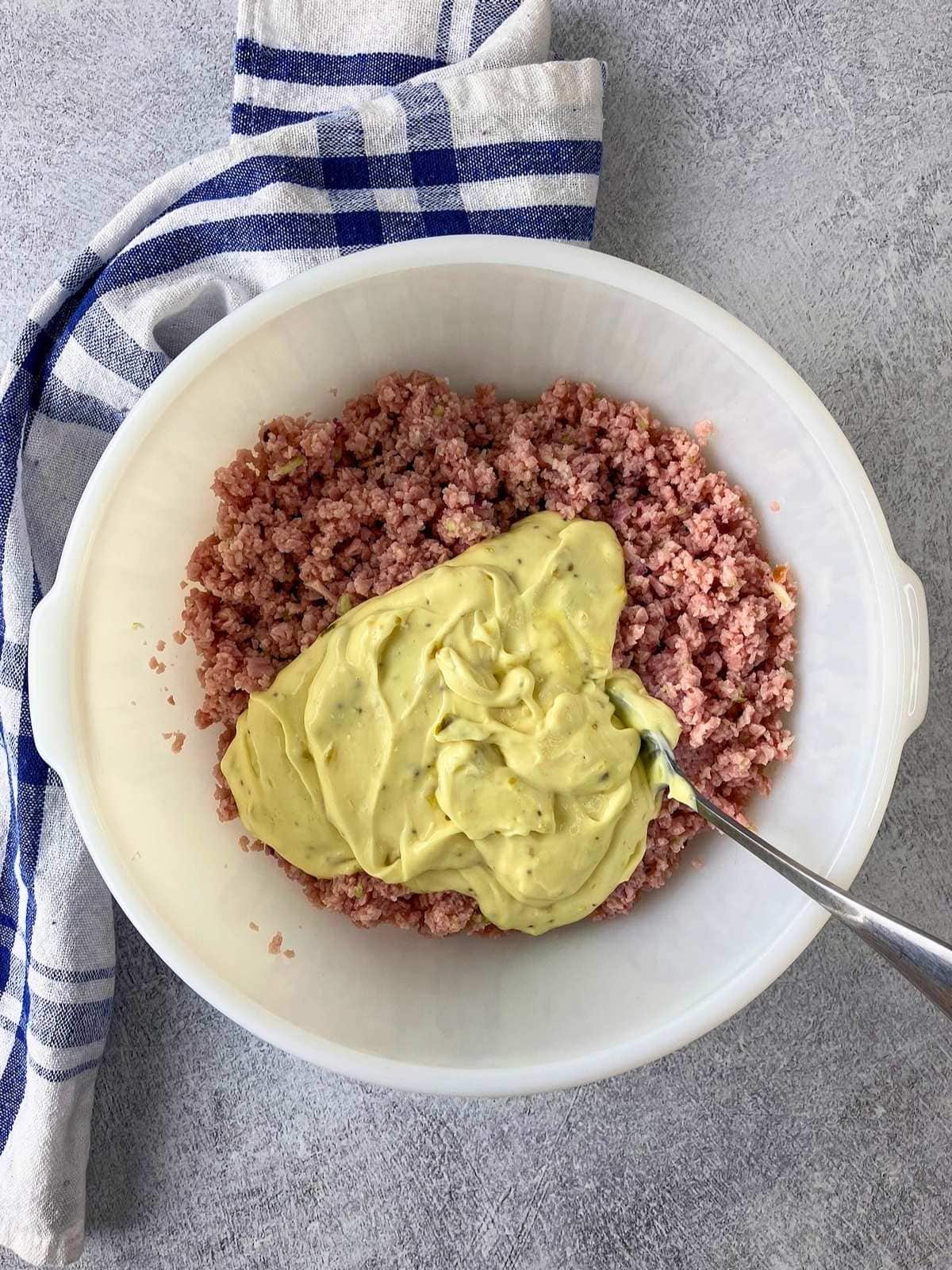 The homemade dressing was added to the chopped ham salad.