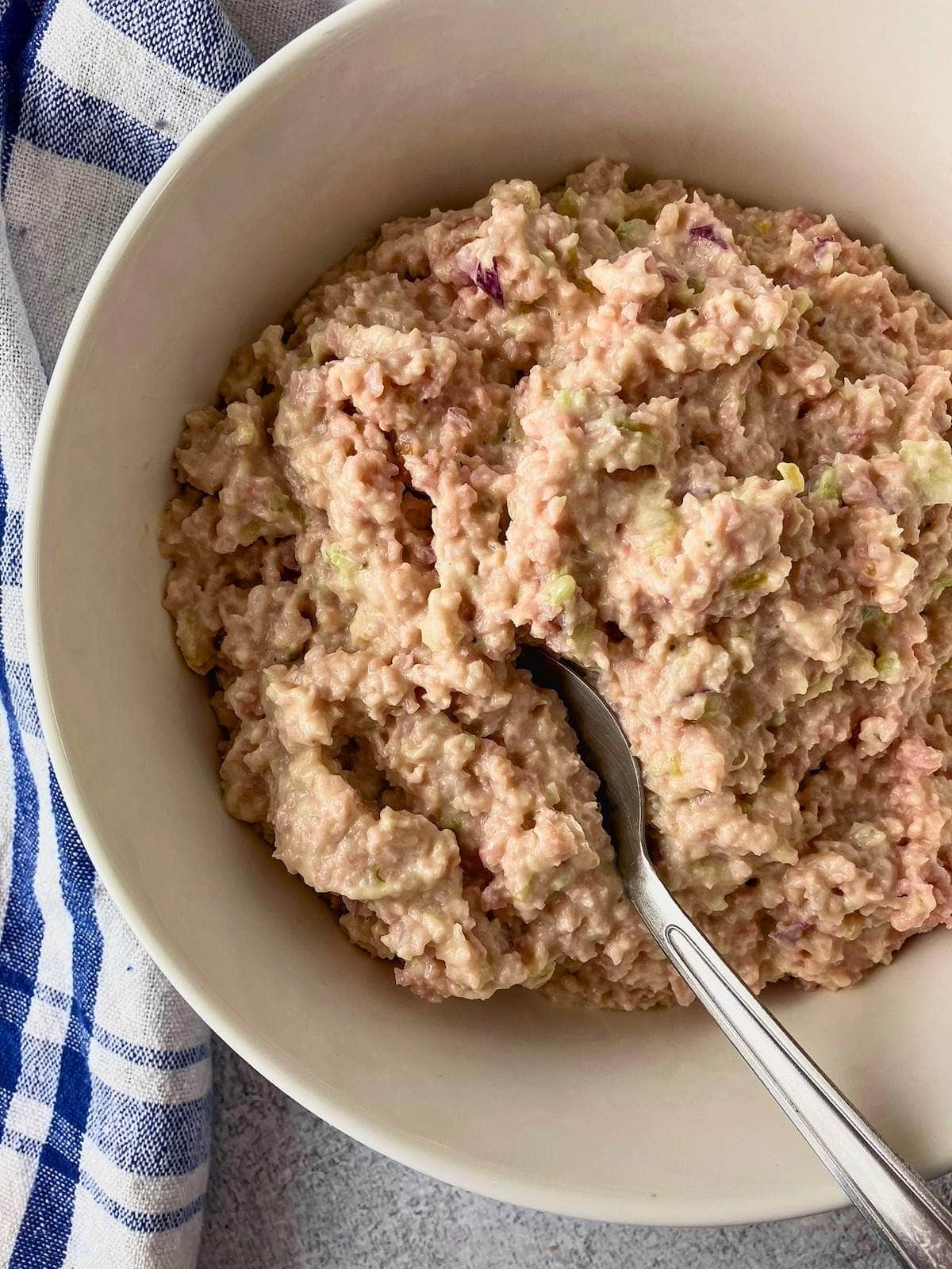 Ham salad in a serving bowl with a spoon.