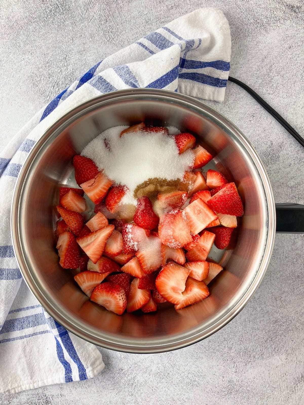 The lemon juice and vanilla extract were added to the sugar and strawberries.