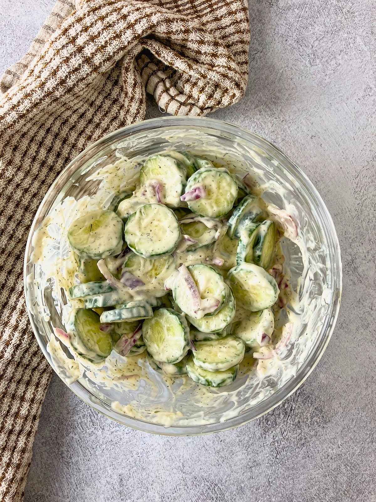 Cucumber salad is mixed together and ready to chill.