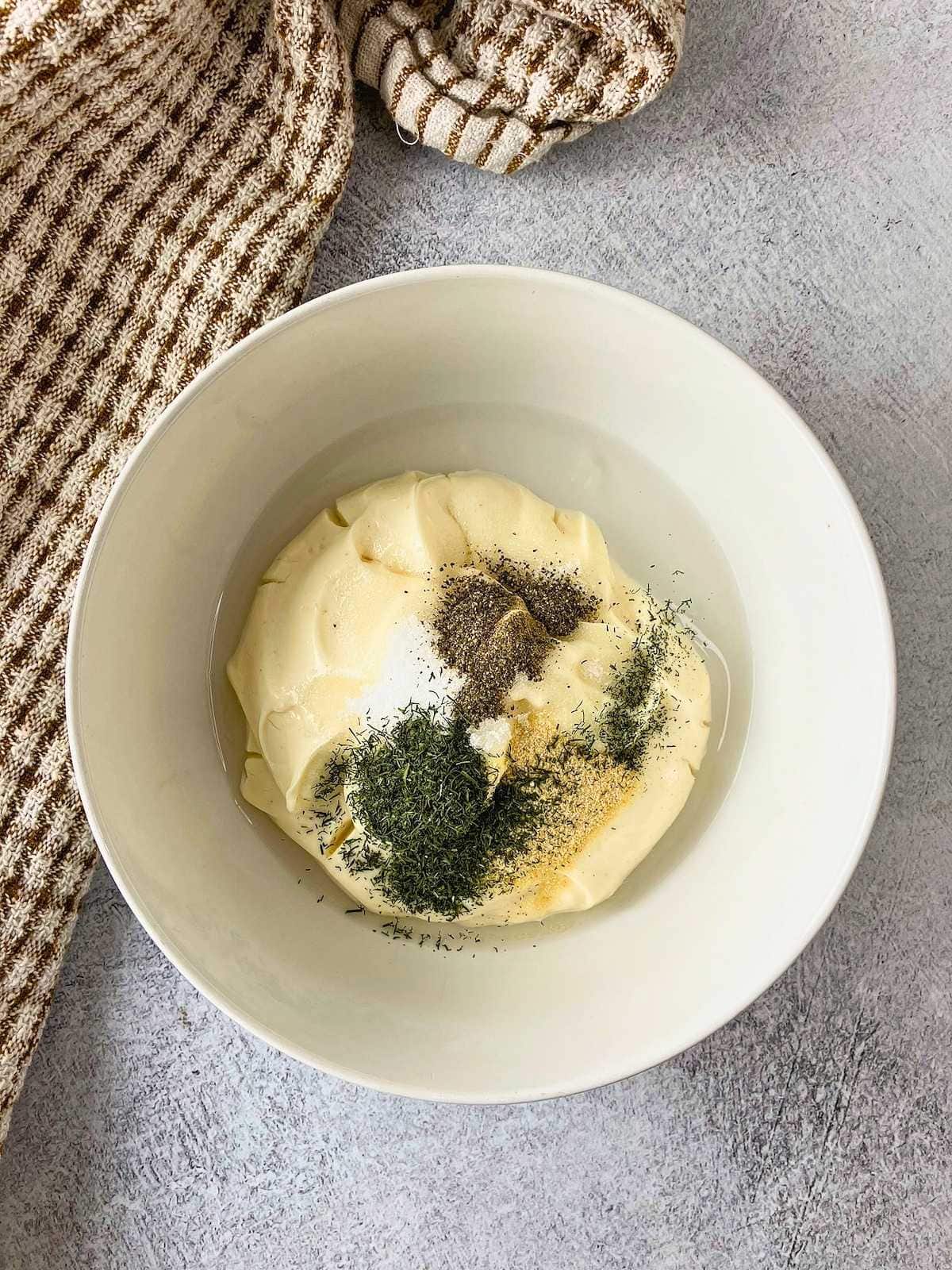 A small bowl with Miracle Whip, sugar, vinegar, and seasonings.
