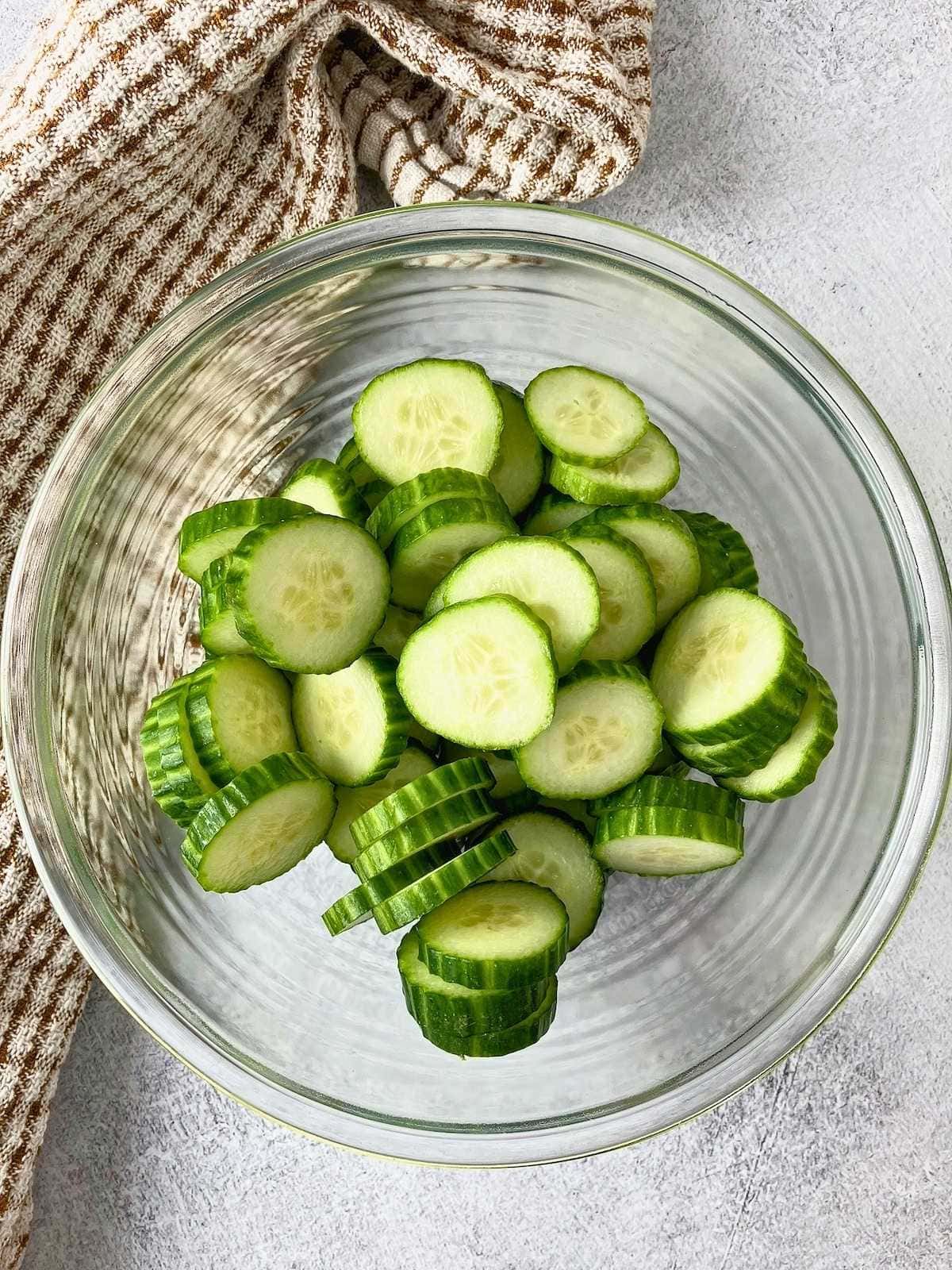 Sliced cucumbers in a mixing bowl.