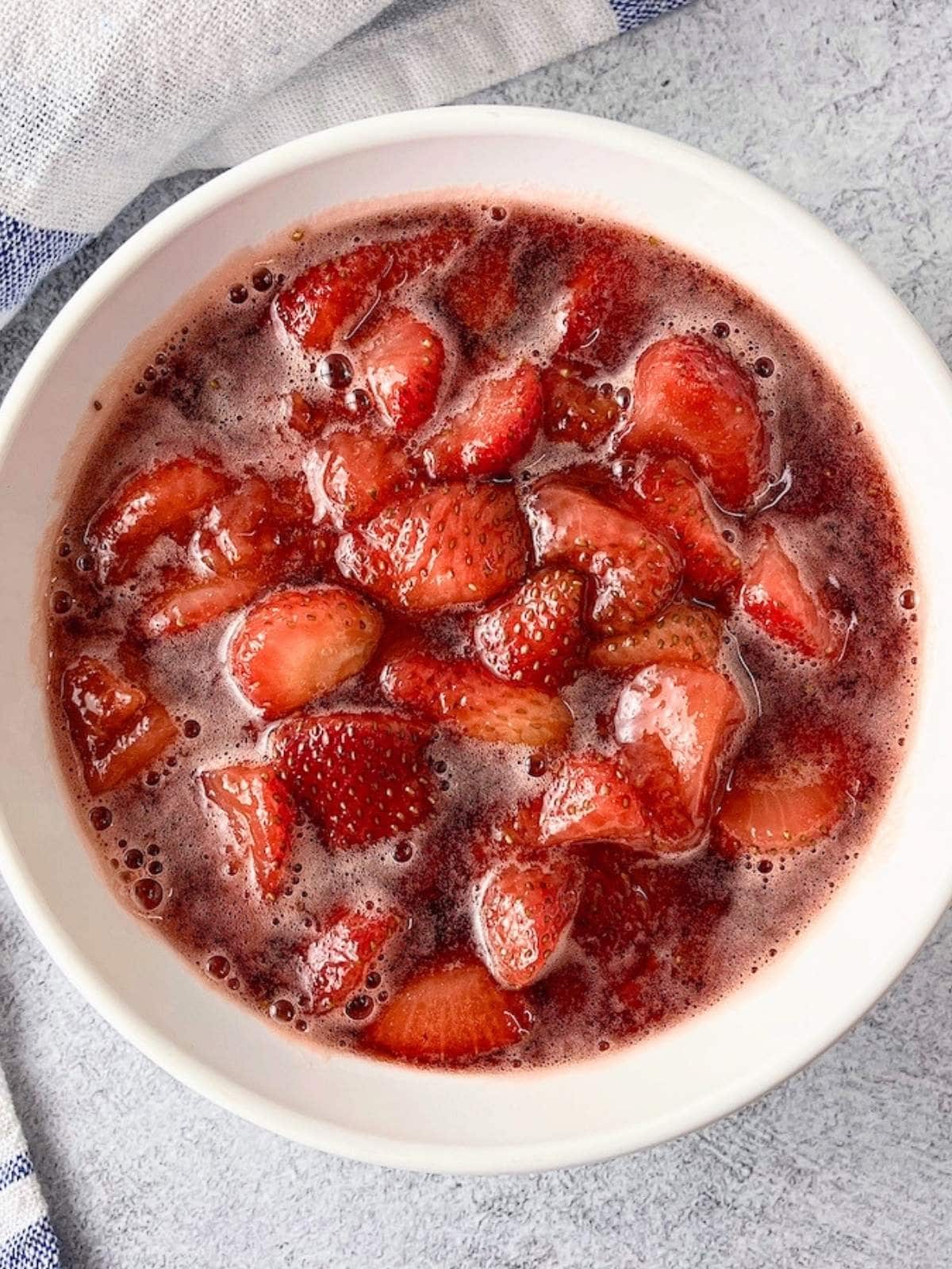 Easy homemade strawberry compote in a white serving bowl.