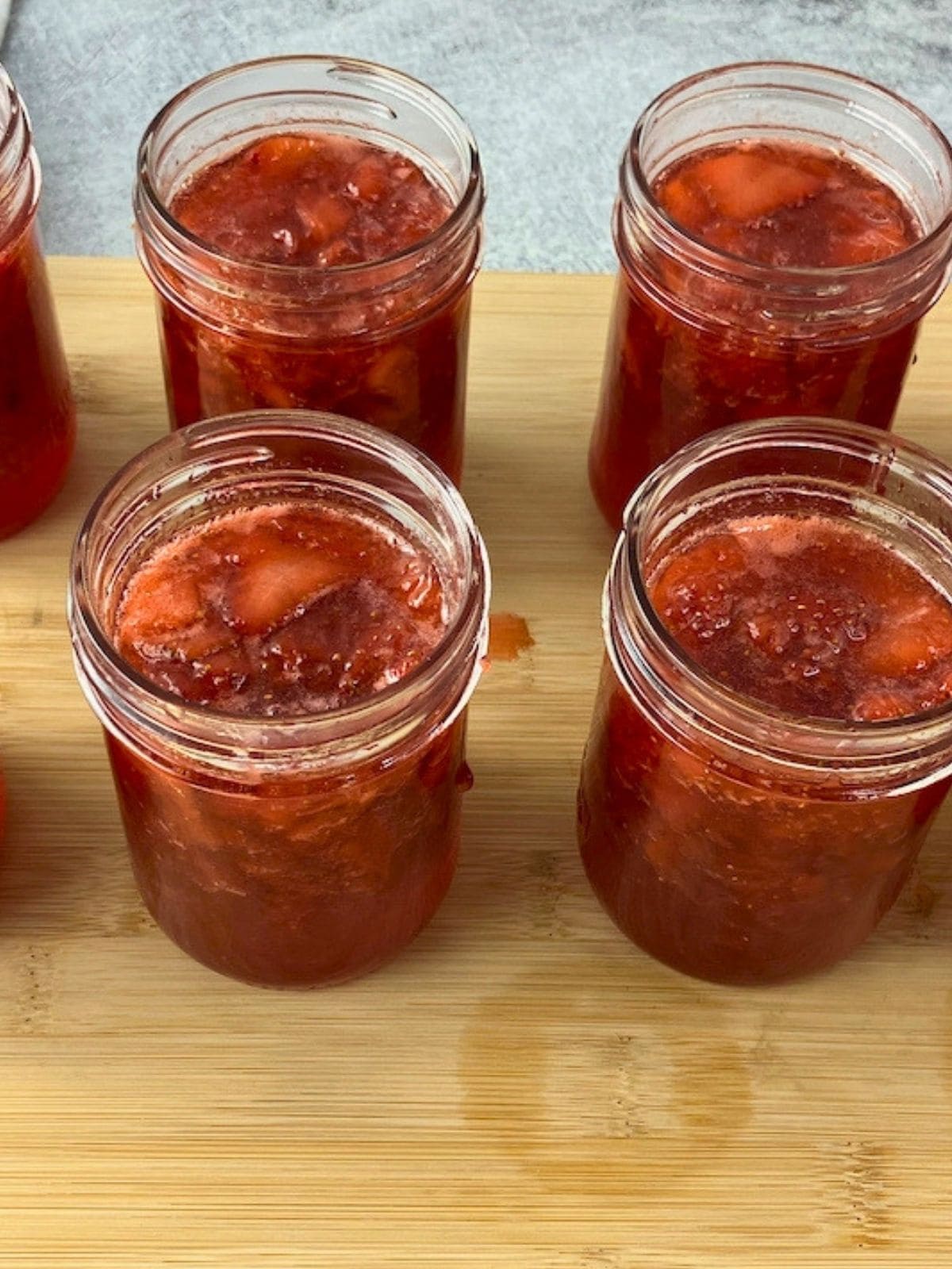 The hot strawberry jam was ladled into the mason jars.