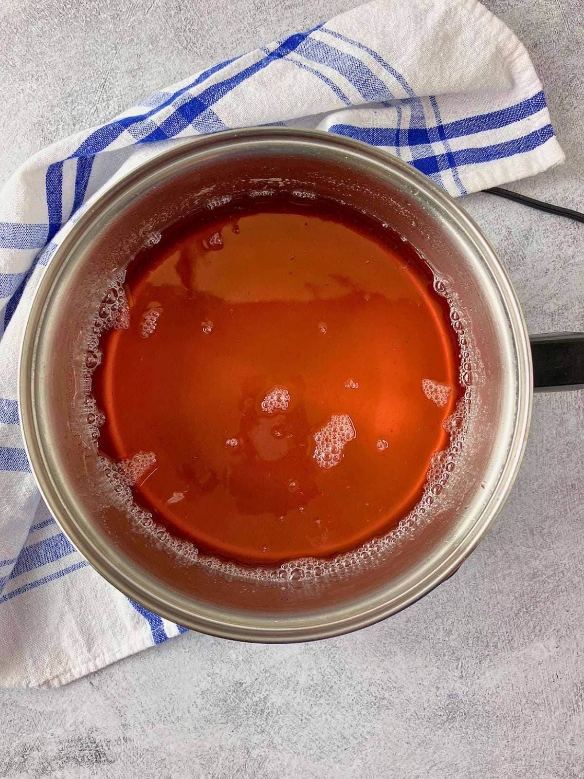 The strained strawberry juice was returned to the saucepan.