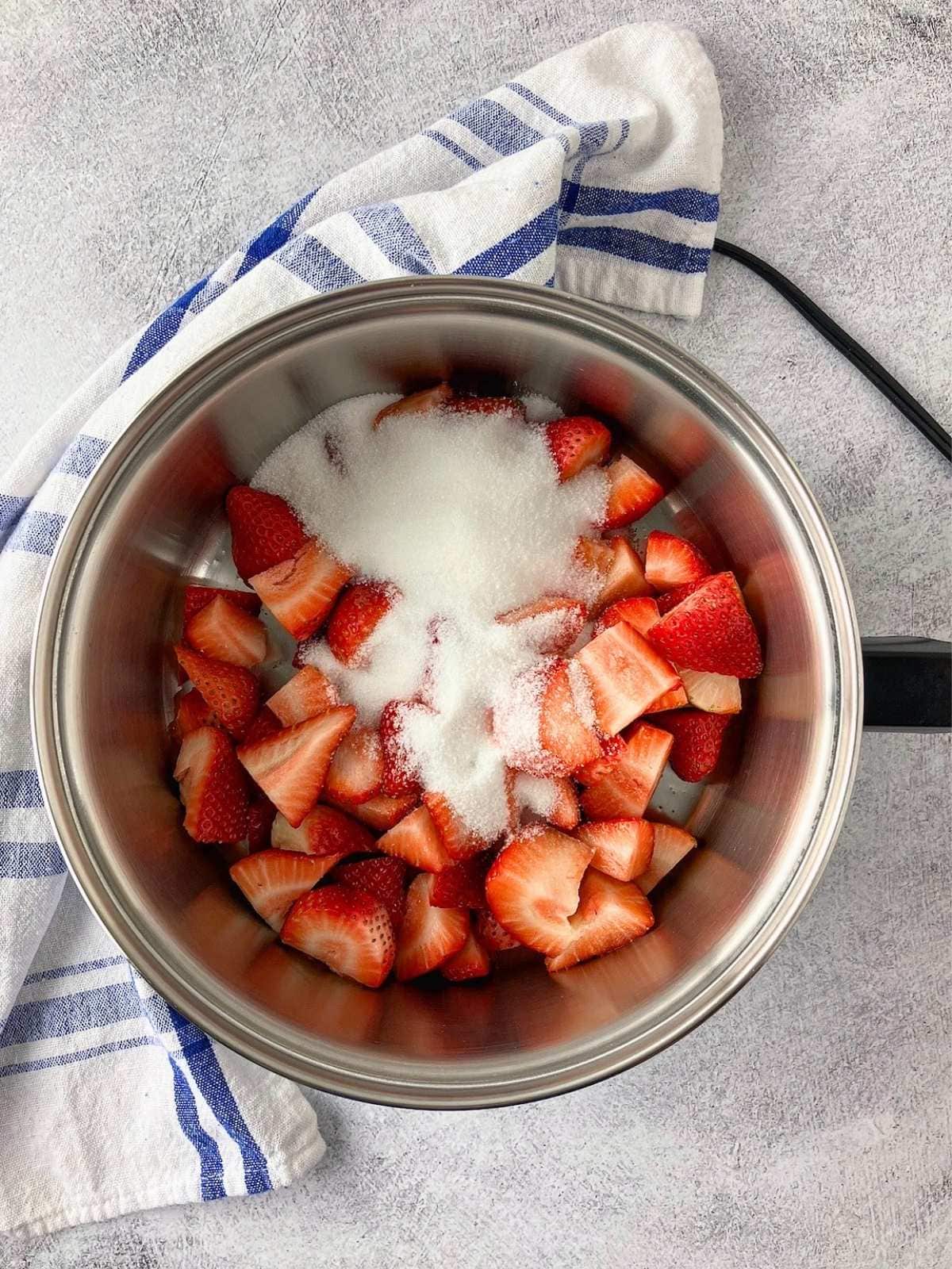 The sugar was added to the strawberries.
