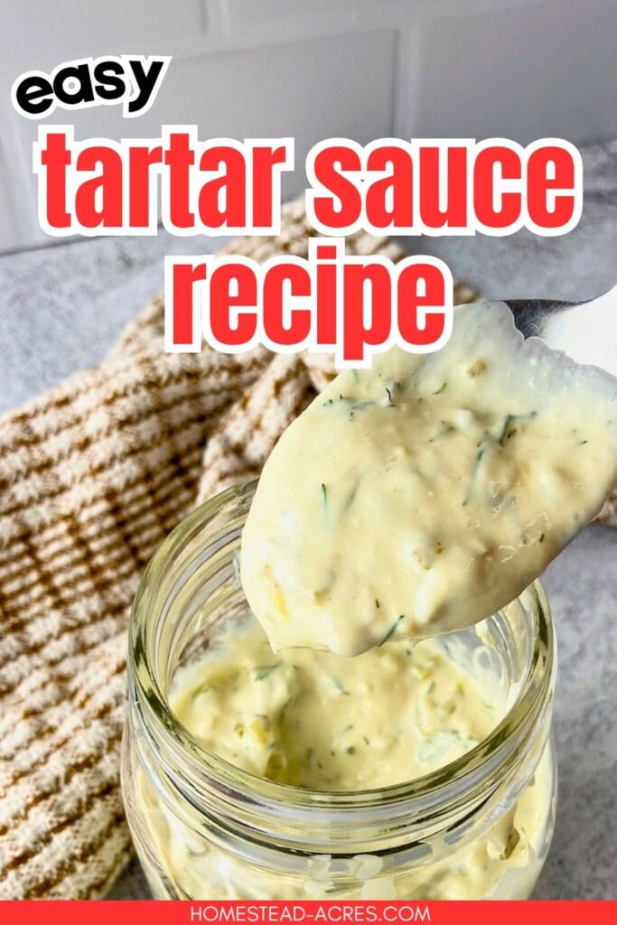 Spoonful of creamy tartar sauce with dill and pickle pieces lifted from a glass jar on a gray counter. Text reads "easy tartar sauce recipe".