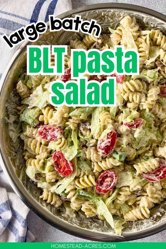Creamy BLT pasta salad with rotini, lettuce, grape tomatoes, and bacon in a metal mixing bowl. The text reads "Large Batch BLT Pasta Salad".